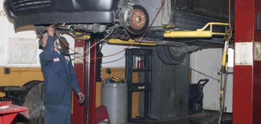 Employee working under car