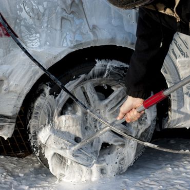 Hands protecting sparkling clean car