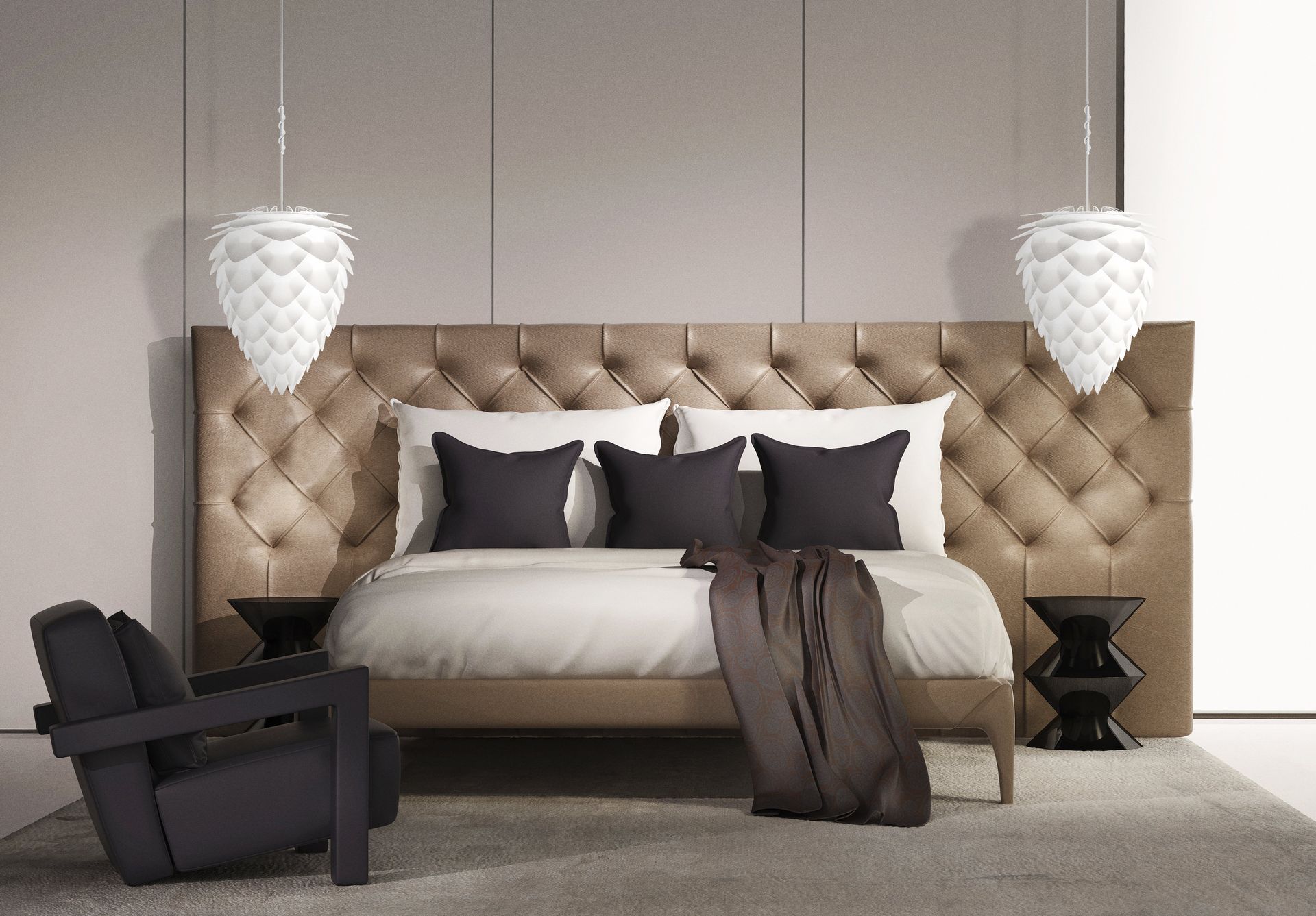 A bedroom with a bed , chair , nightstand and lamps.