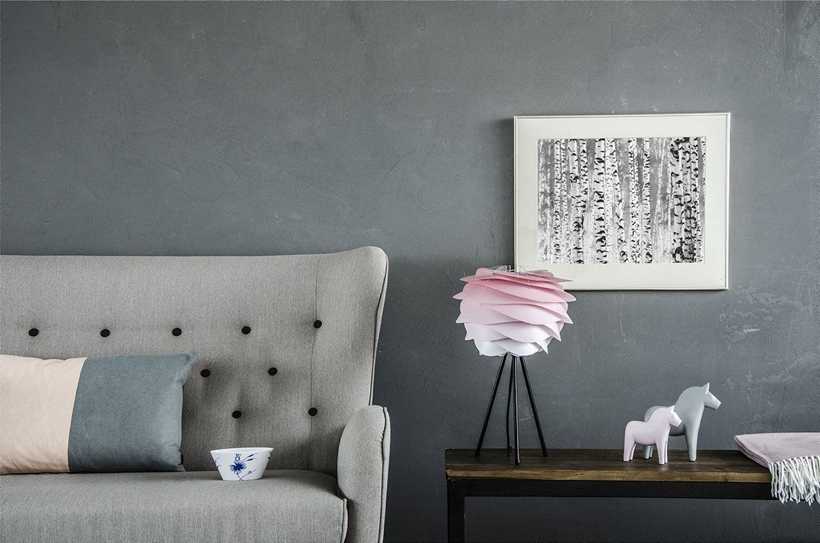 A living room with a couch a table and a picture on the wall