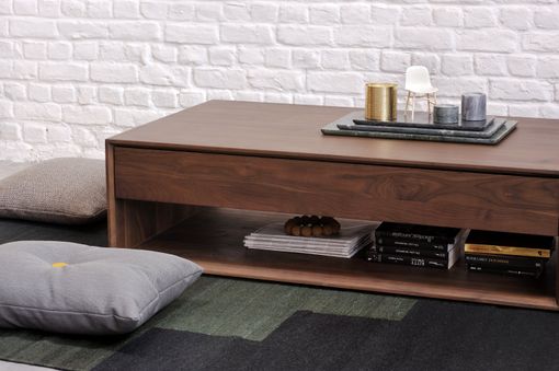 A wooden coffee table with a tray on top of it in a living room.