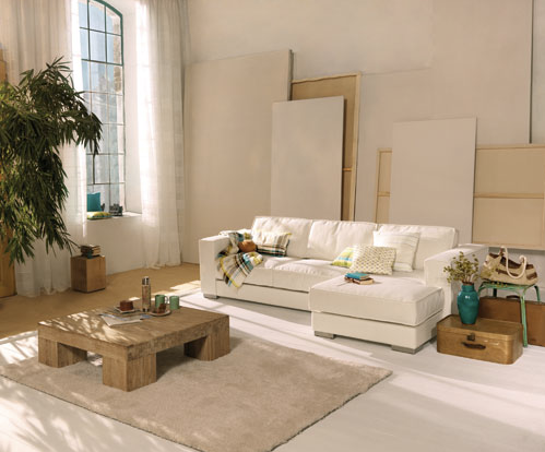 A living room with a white couch and a coffee table