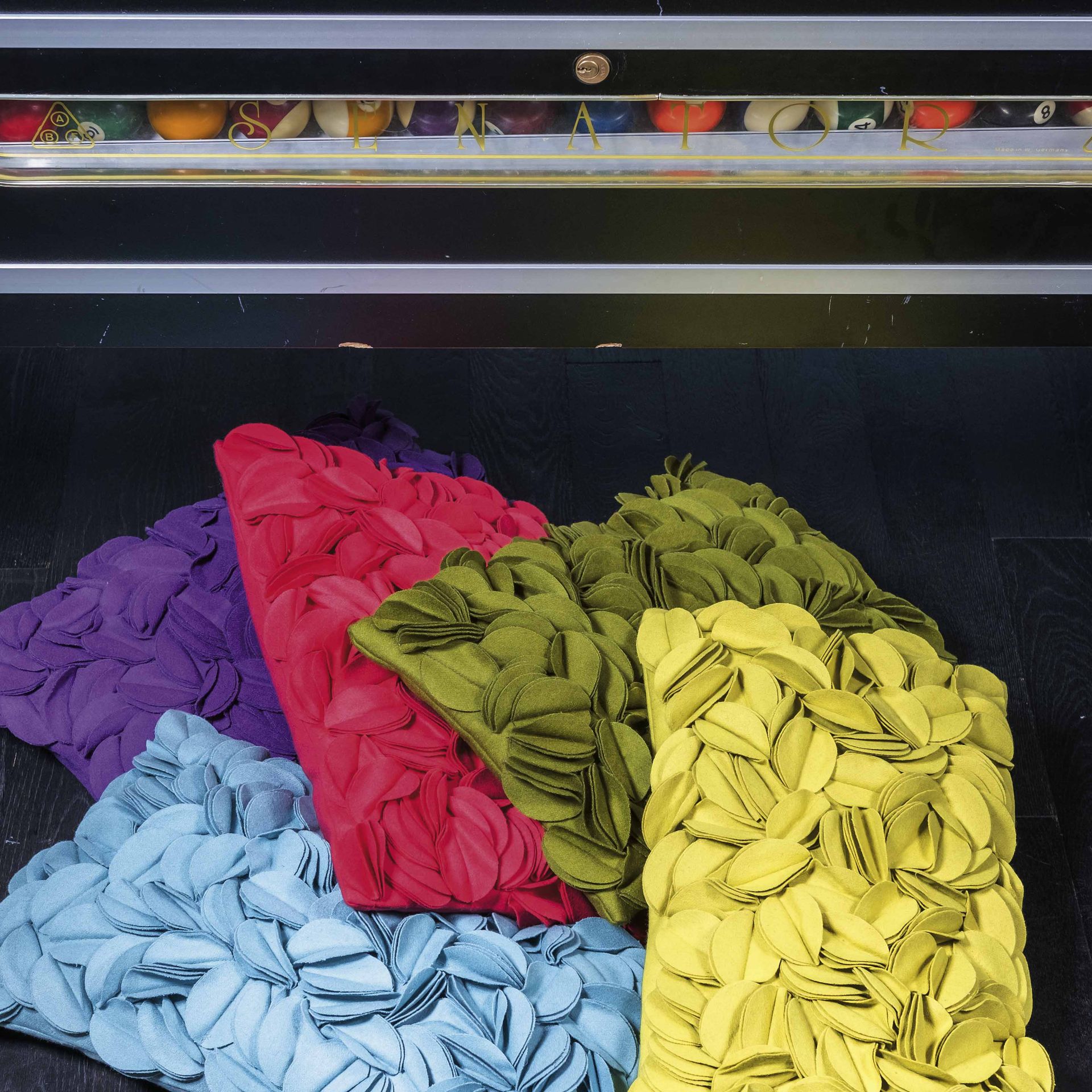 A bunch of colorful pillows are stacked on top of each other