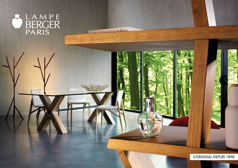 A living room with a lampe berger paris sign on the wall