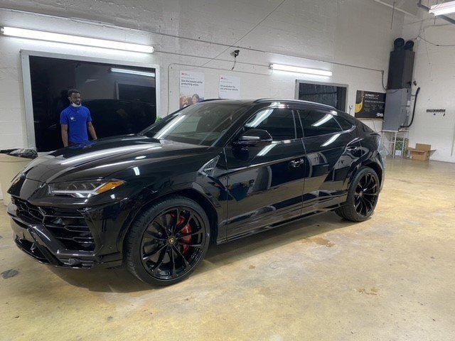 Worker And A Black Car — Miami, FL — Solar Tint, Inc.