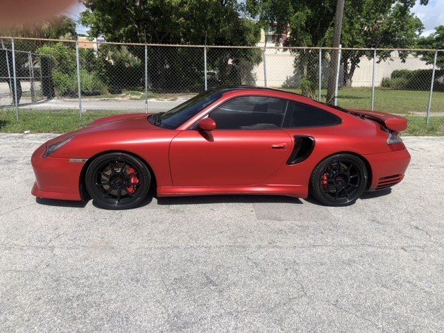 Red Automobile On The Road — Miami, FL — Solar Tint, Inc.