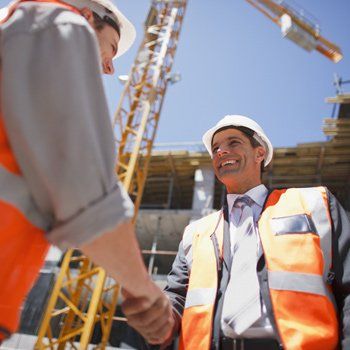 Surety Bond Agents — Construction Worker Shaking Hands With Co-Worker in Sacramento, CA Surety Bond Agents — Construction Worker Shaking Hands With Co-Worker in Sacramento, CA