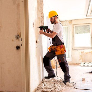 Surety Bonds — Experienced Worker Using Hammer Drill in Sacramento, CA