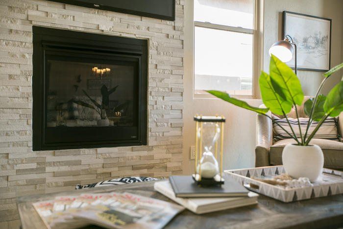 A living room with a fireplace and a coffee table.