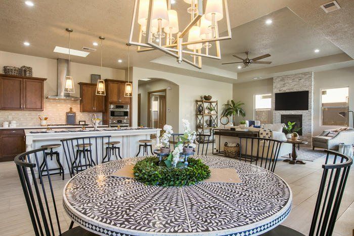 There is a round table with a wreath on it in the middle of the room.