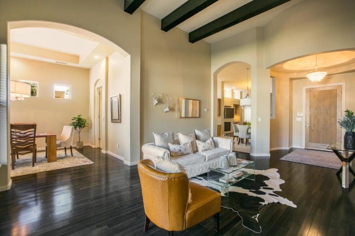 A living room with a couch , chair , table and rug.