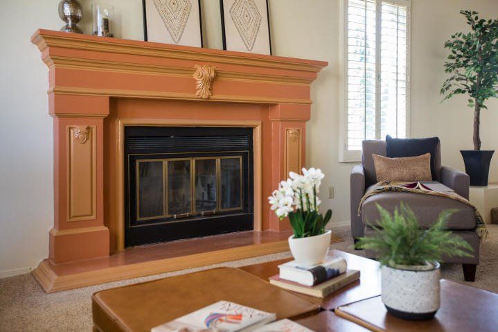 There is a fireplace in the middle of the living room.