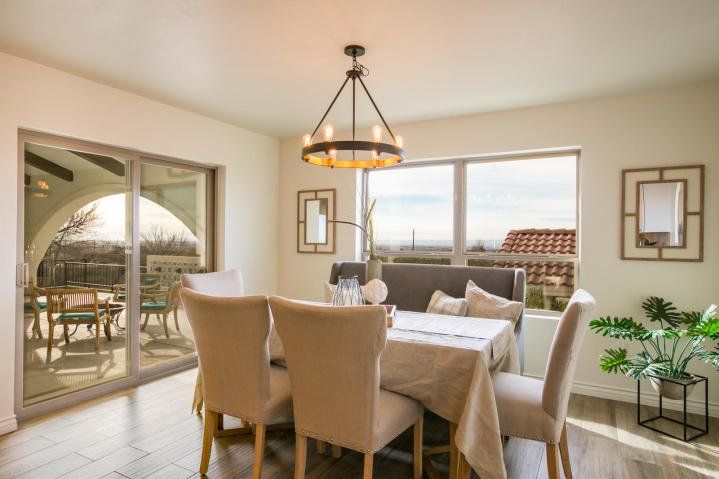 A dining room with a table and chairs and a chandelier