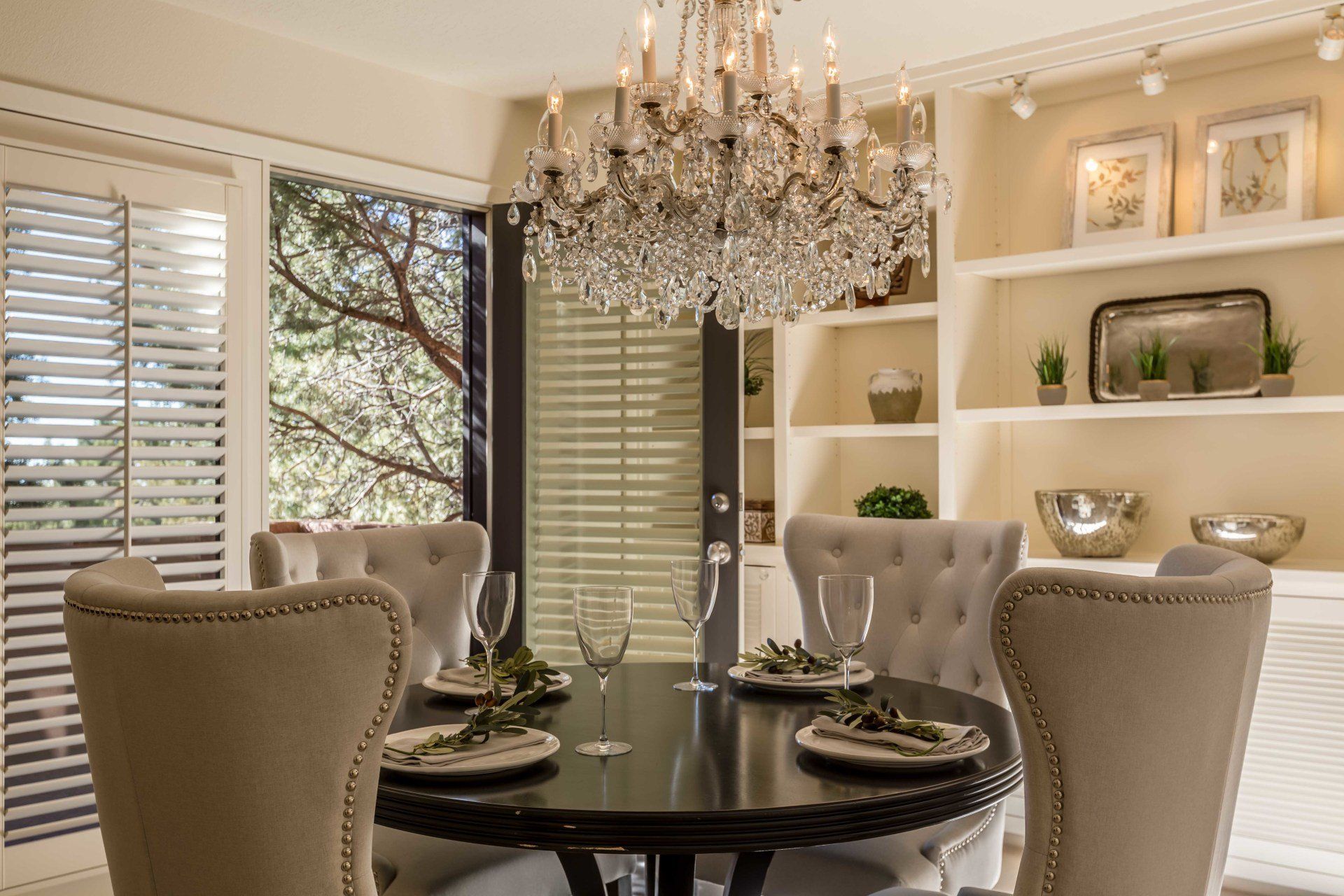 A dining room with a table and chairs and a chandelier