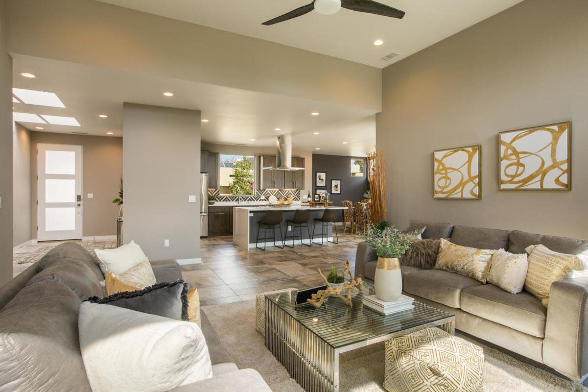 A living room filled with furniture and a ceiling fan.