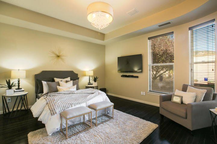 A bedroom with a bed , chair , and television.