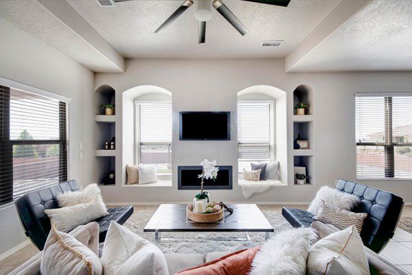 A living room with a fireplace and a flat screen tv