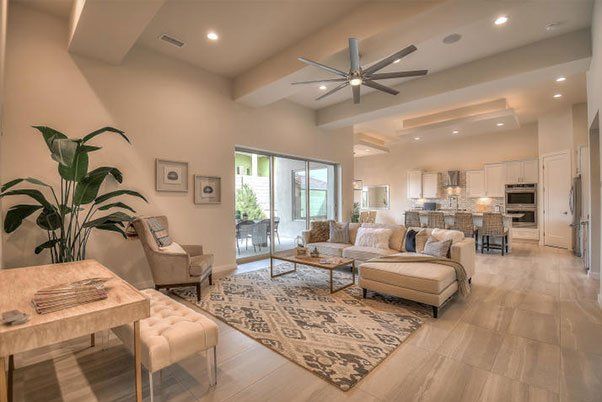 A living room filled with furniture and a ceiling fan.