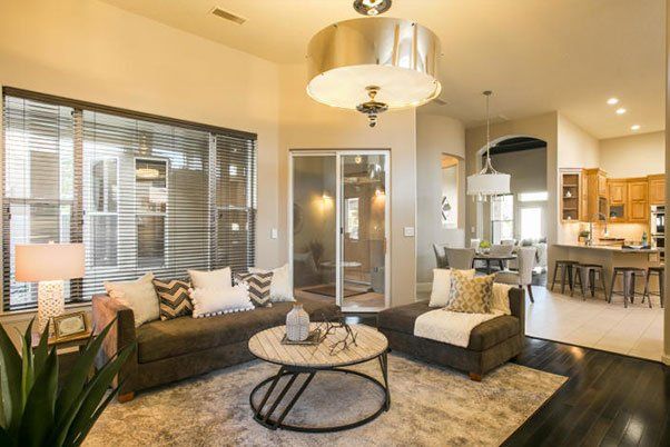 A living room with two couches , a coffee table , and a sliding glass door.