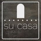 The logo for su casa is on a concrete surface.