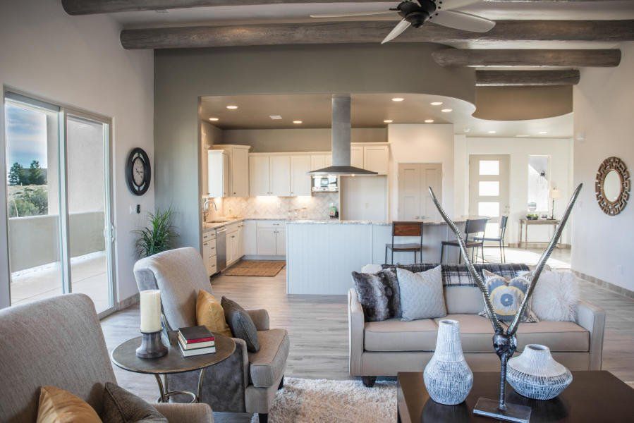 A living room filled with furniture and a ceiling fan.