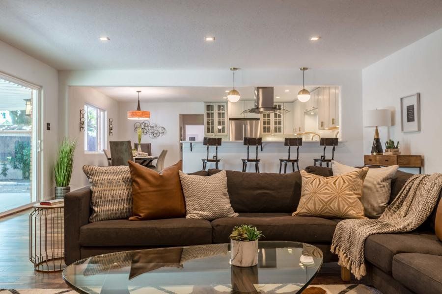 A living room filled with furniture and a glass coffee table.