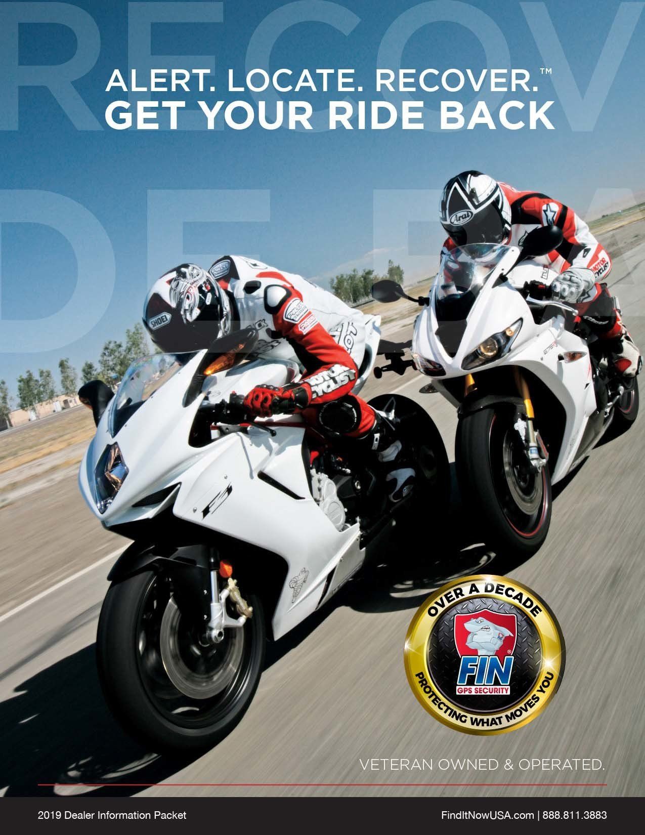 Two people are riding motorcycles on a road.