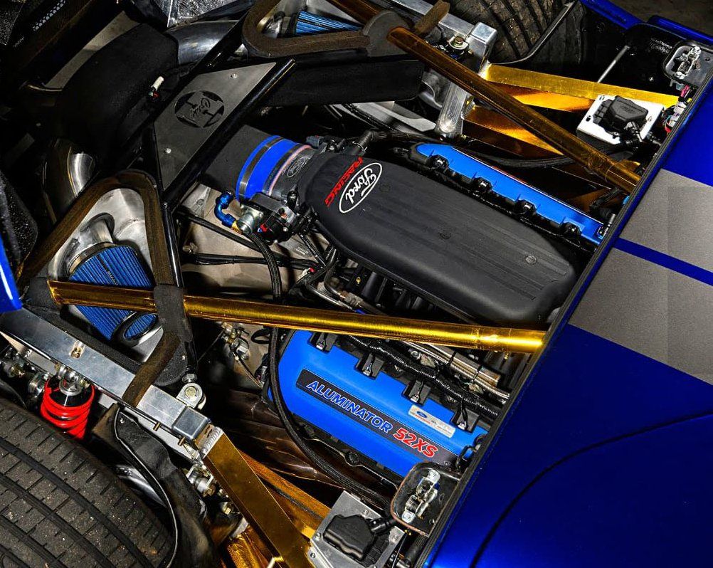 A close up of a ford engine in a blue car