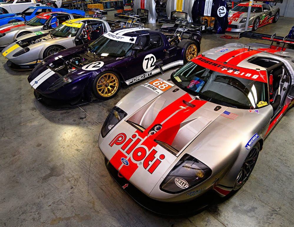 A row of racing cars with one that says piloti on the front
