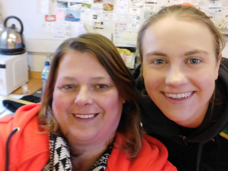 Two members of staff smiling for camera