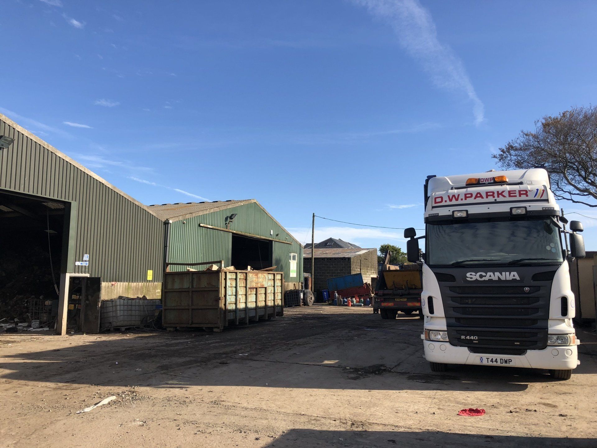 White truck beside warehouse