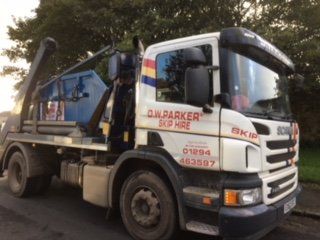 Front of white truck with raised trailer behind