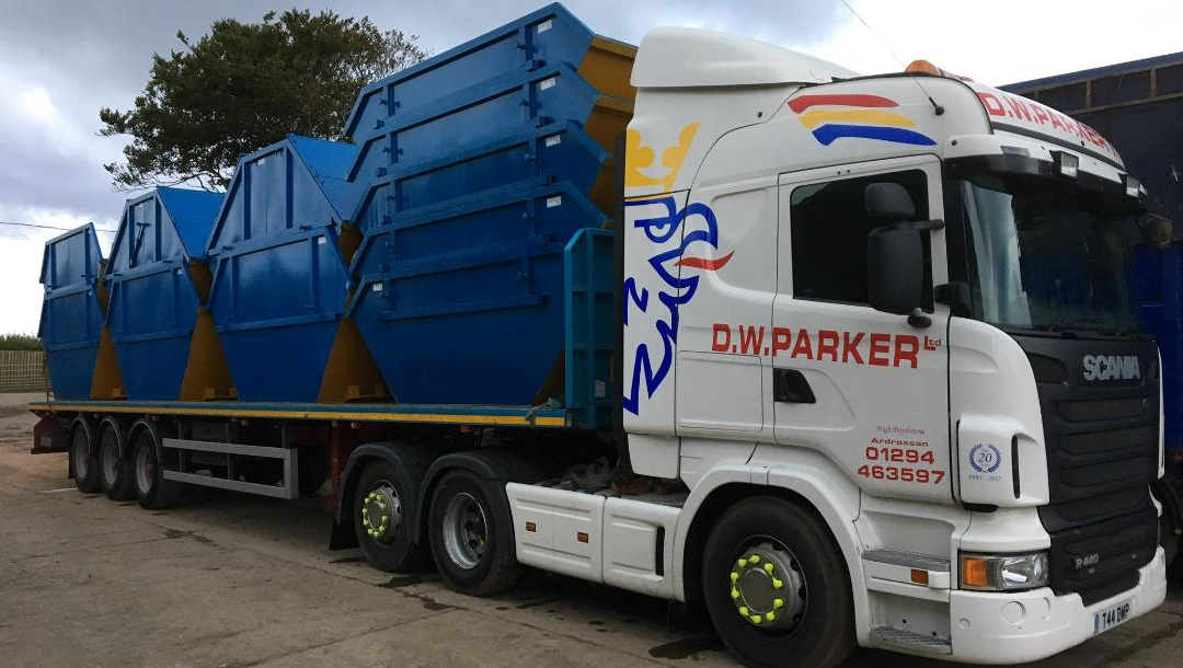 White truck with multiple skips