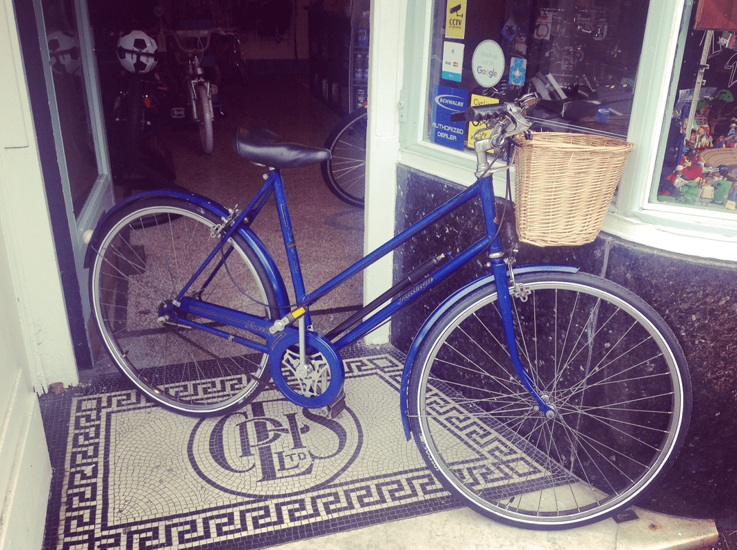 Royal blue bike outside the shop