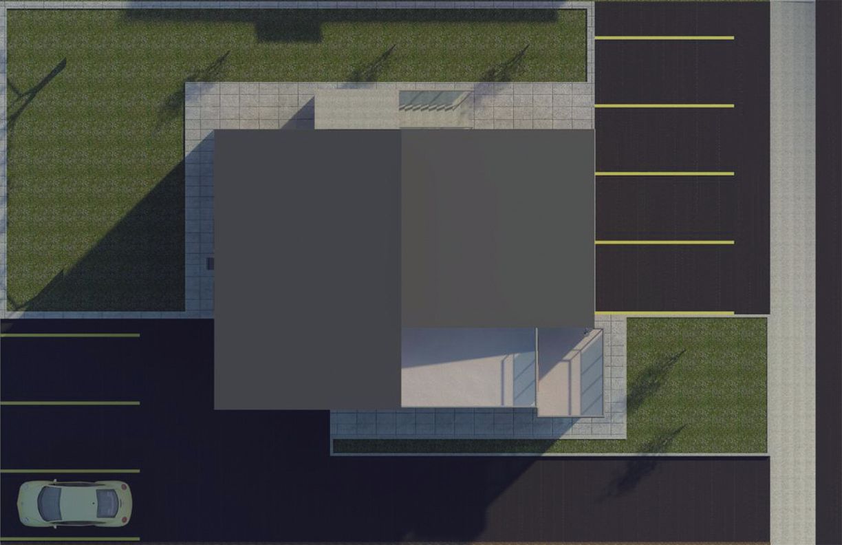 A top-down architectural site plan showing a rectangular building, paved parking areas, and green landscaping.