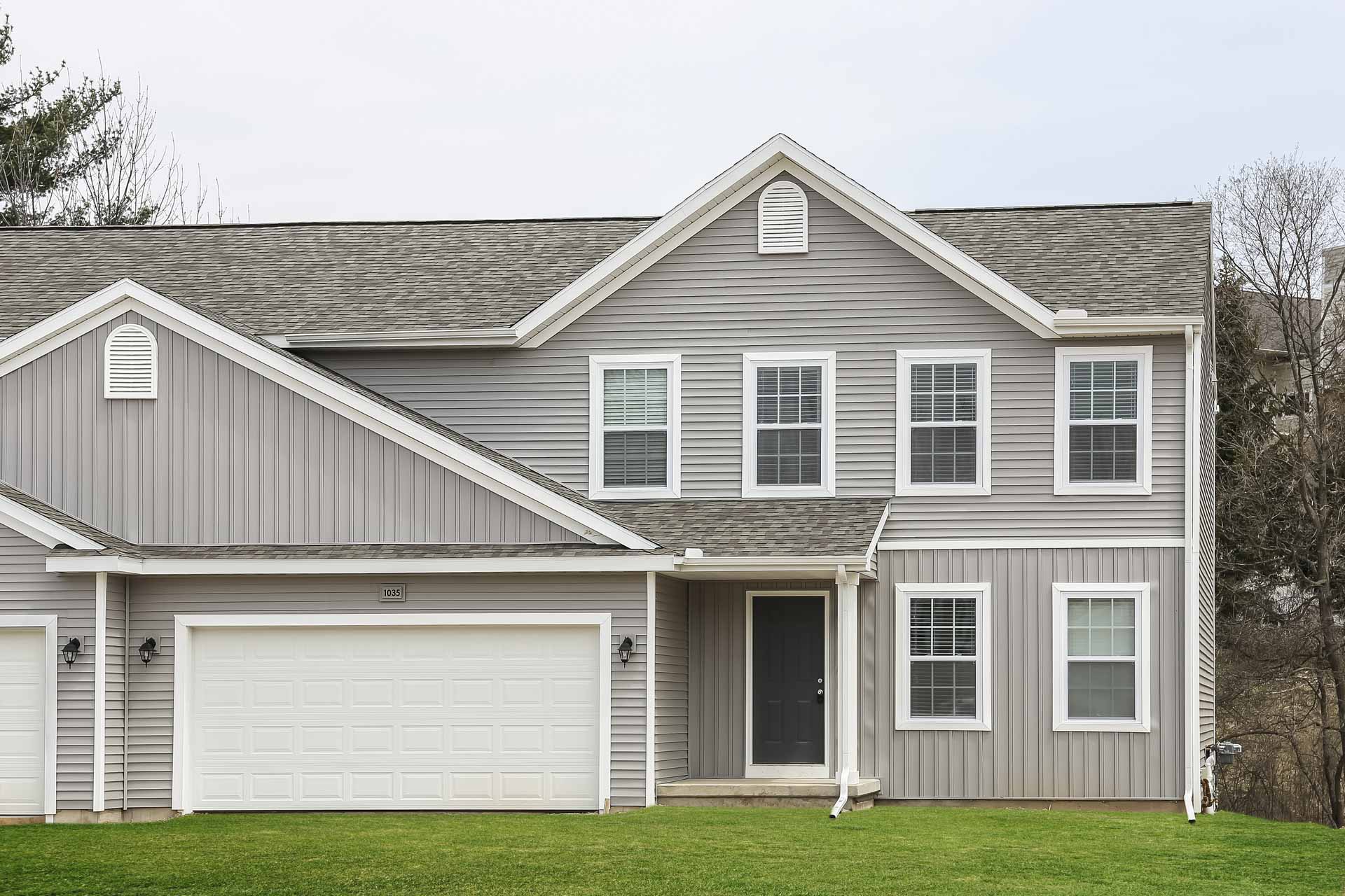 New Copper Bay home exterior with attached garage and covered front porch