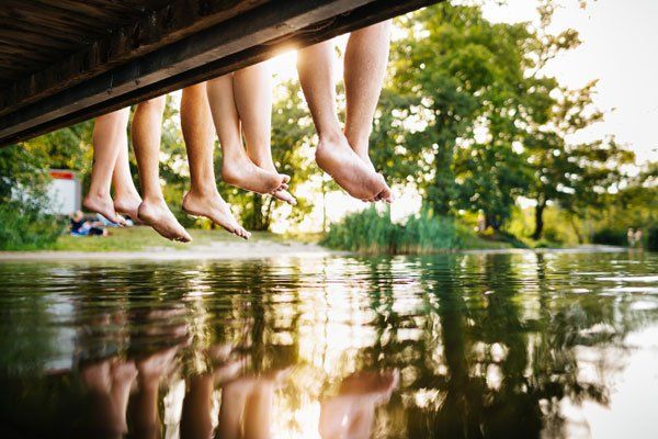 feet dangling from dock