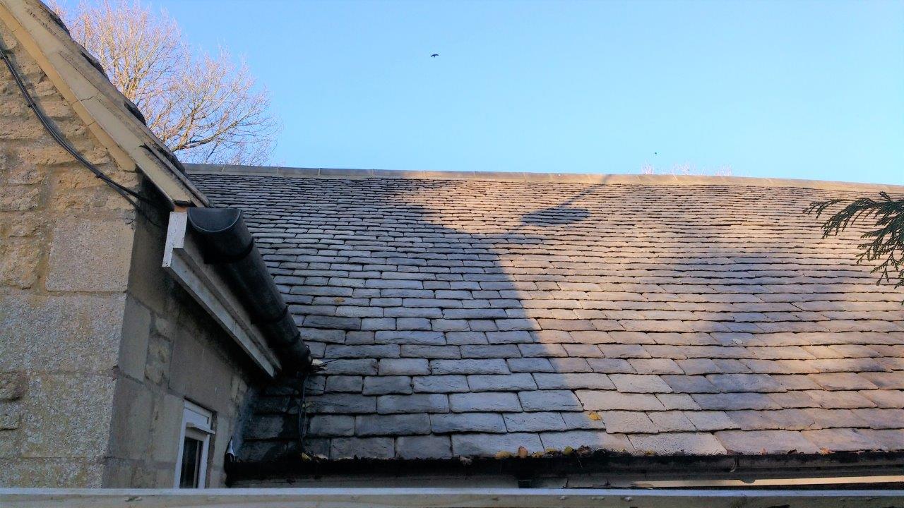 A roof of a building with a blue sky in the background
