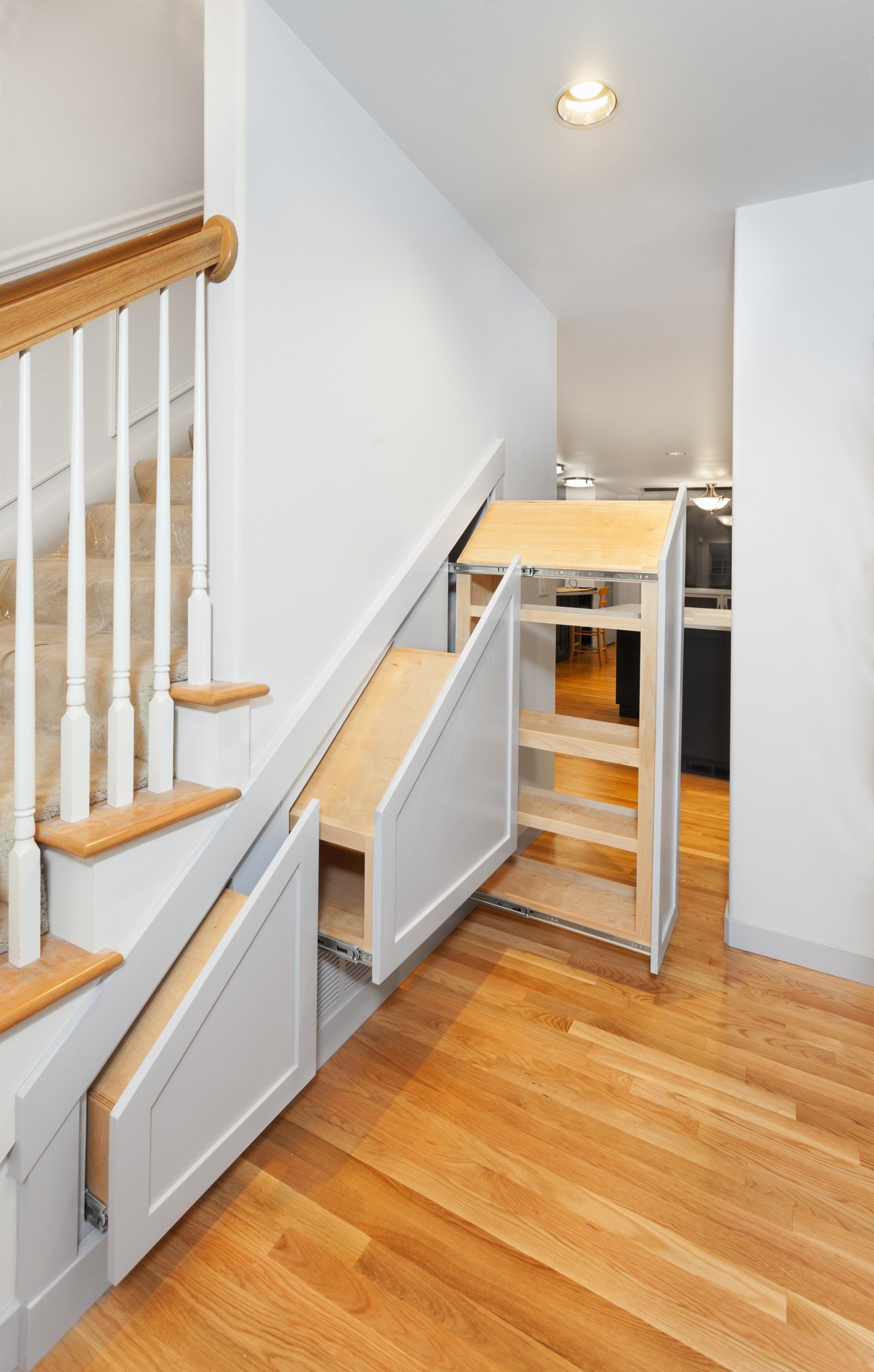 A staircase with a drawer underneath it that looks like a slide.