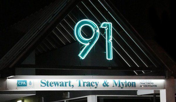 Neon sign for stewart, tracy and mylon sign