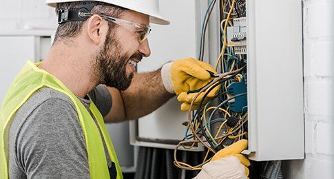 Electrician Repairing Electric Box — Clive, IA — Bartlett Electric