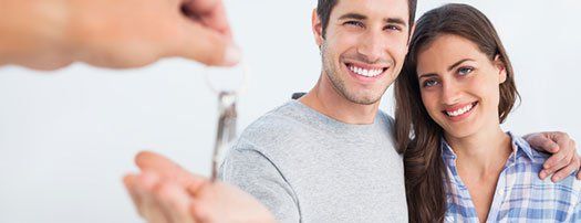 Happy Couple Being Given a House Key — Home security in Annapolis, MD