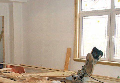 A circular saw is sitting in a room next to a window.
