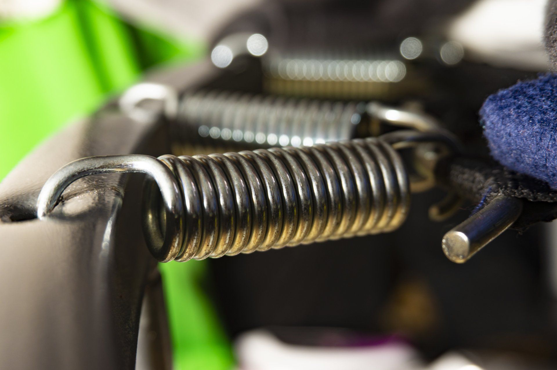 A close up of a metal spring on a trampoline