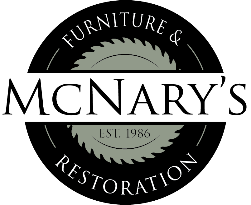 The logo for mcnary 's furniture and restoration has a saw blade on it.
