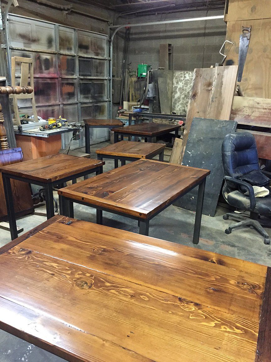 A room filled with wooden tables and chairs.