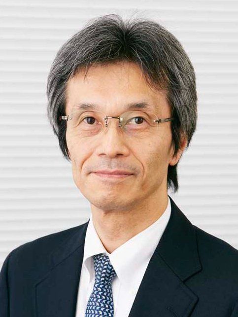 A man in a suit and tie is wearing glasses.