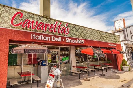 Cavaretta’s Italian Deli storefront with red awnings, outdoor seating, and “Since 1979” signage