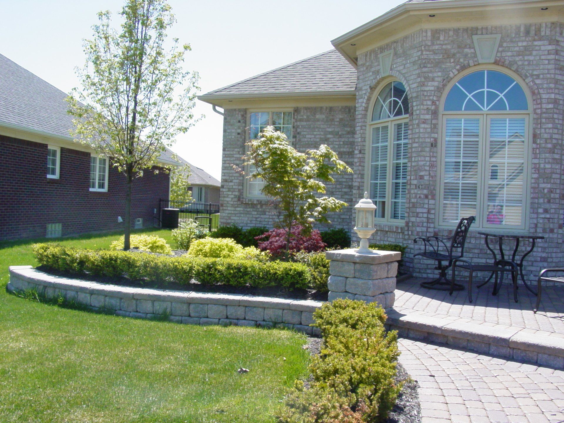 A brick house with a table and chairs in front of it