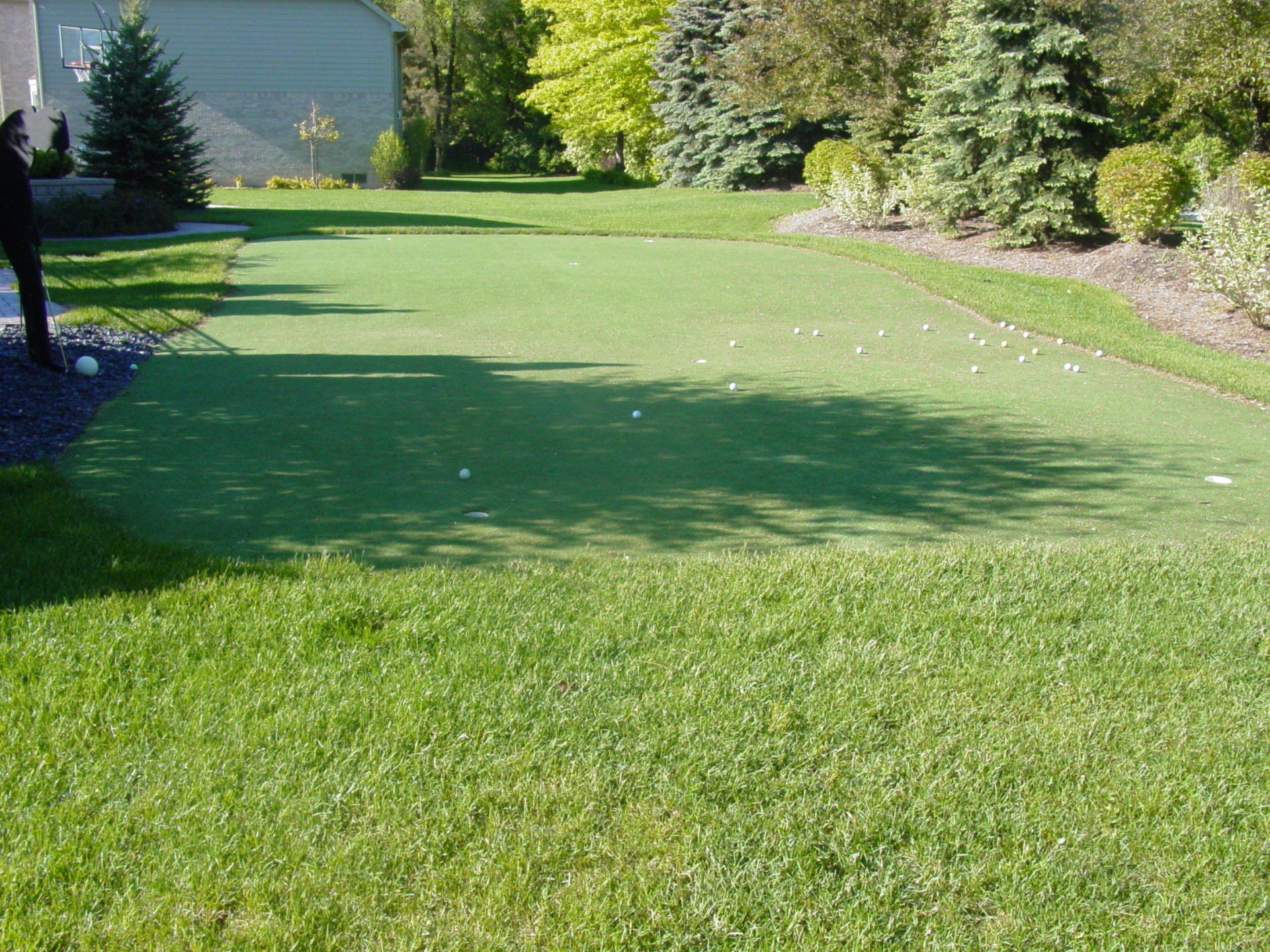 A person is standing on a golf course with a ball in their hand